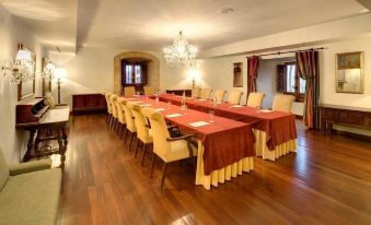 a large conference room with multiple long tables and chairs arranged for a meeting or event at Parador de Leon - San Marcos