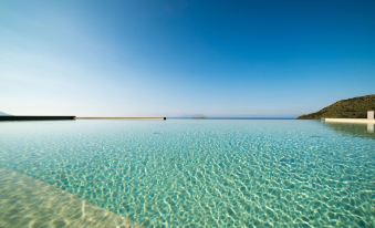 a large body of water , possibly an ocean or a lake , with a clear blue sky overhead at Best Western Plus Hotel Terre di Eolo