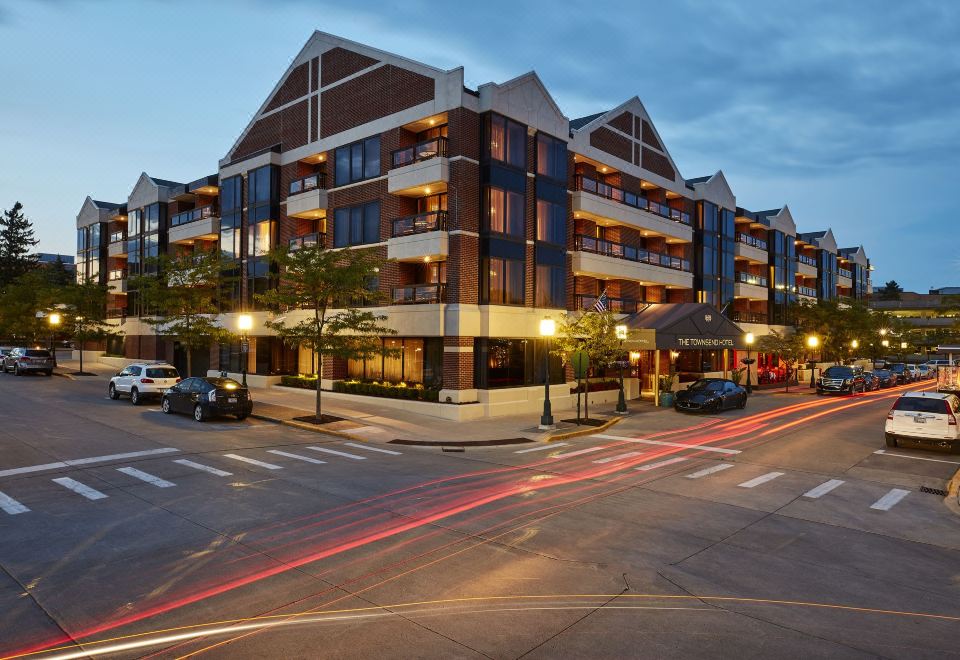 a modern , two - story building with multiple balconies and a street scene in front of it at The Townsend Hotel