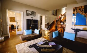 a spacious living room with two couches , a television , and a staircase leading to the second floor at Villa la Tosca