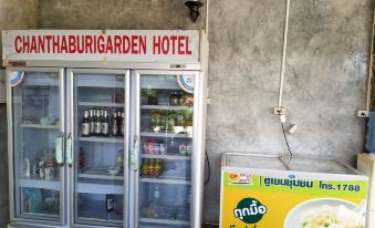 a refrigerated display case with various beverages and snacks , located in front of a building at Chanthaburi Garden Hotel