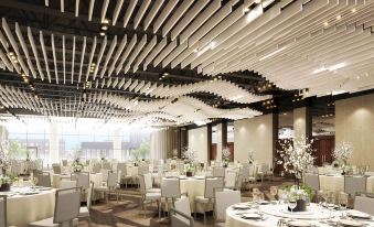 a large banquet hall with multiple tables and chairs arranged for a formal event , possibly a wedding reception at Renaissance Dallas at Plano Legacy West Hotel