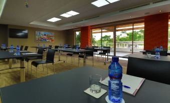 a conference room with a table , chairs , and water bottles set up for a meeting at Peduase Valley Resort
