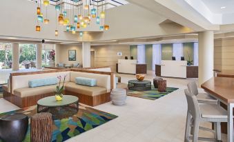 a modern hotel lobby with various seating options , including couches , chairs , and a dining table at The Westin St. John Resort Villas