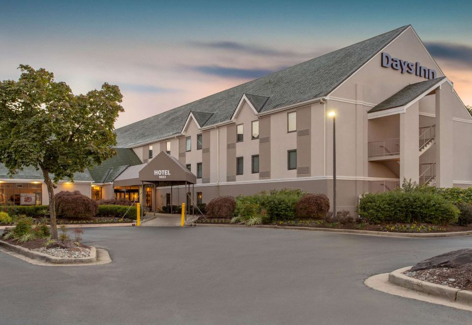 a fairfield inn & suites hotel with its name displayed on the building , surrounded by trees and a parking lot at Days Inn by Wyndham Lanham Washington DC