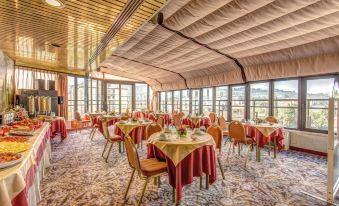 a large dining room with multiple tables and chairs , all set up for a formal event at Hotel Europa