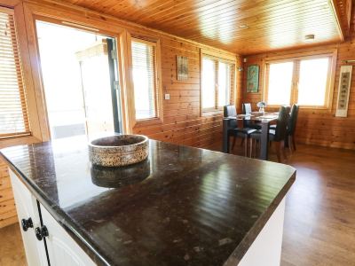 a kitchen with wooden walls and a marble countertop , featuring a bowl on the island at Moon Face