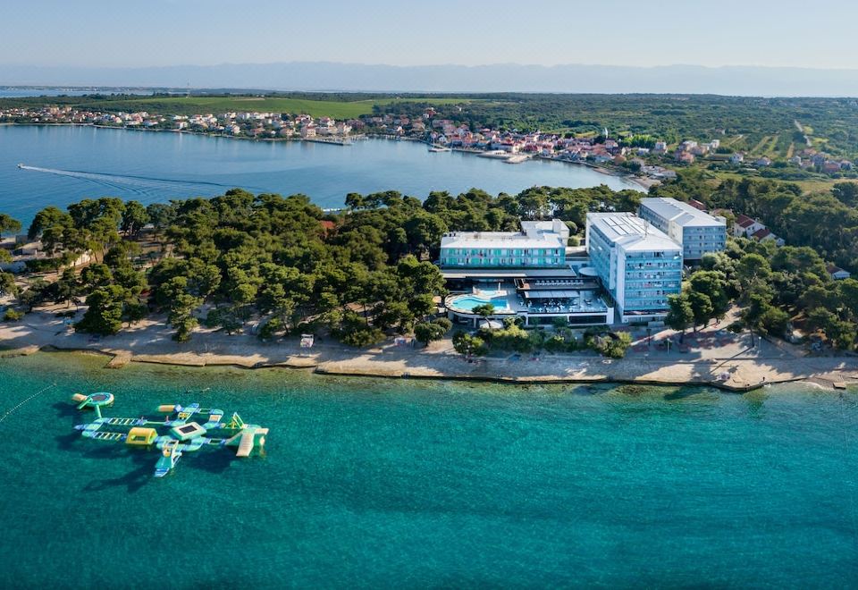 aerial view of a resort surrounded by water , with a dock extending into the lake at Hotel Pinija