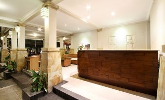 The reception desk is situated in the open-concept lobby of the hotel at The Niche Bali