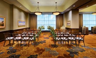 a room with rows of chairs and tables set up for an event , possibly a wedding or conference at Hyatt Regency Calgary