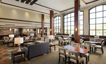 a large , well - lit dining area with multiple tables and chairs arranged for guests to enjoy a meal at Staybridge Suites Washington DC East - Largo