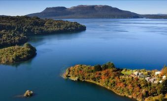 aerial view of a large body of water with a small island and a few buildings on it at All Seasons Holiday Park