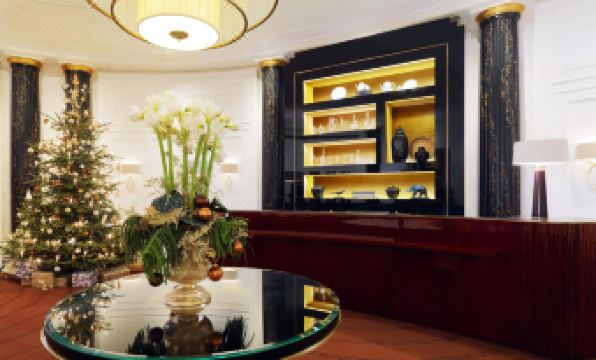 a well - decorated room with a glass table , black and white furniture , and a yellow shelf at Hotel Bristol, a Luxury Collection Hotel, Vienna