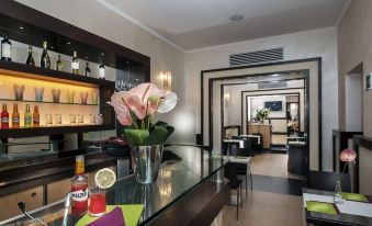 a well - equipped home bar area with a glass counter , several chairs , and a dining table at Yes Hotel