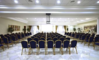 a large conference room with rows of chairs arranged in a semicircle , providing seating for attendees at Bahia Principe Grand la Romana - All Inclusive