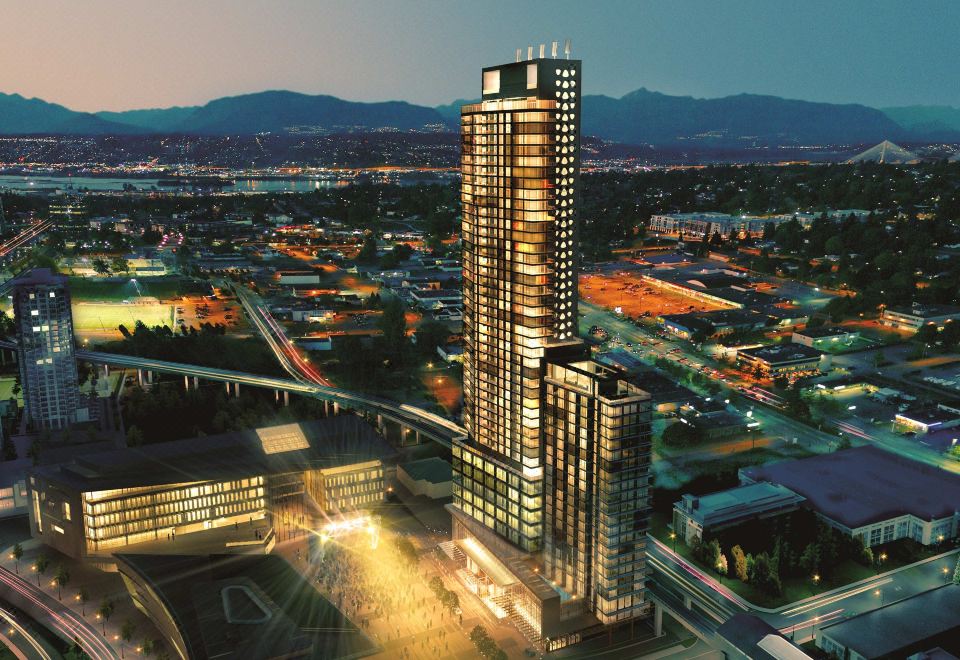 a tall , modern building with a black exterior and lit windows is surrounded by other buildings in a city at night at Civic Hotel, Autograph Collection