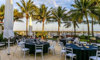 a restaurant patio with tables and chairs set up for guests to enjoy a meal at Mantra Mackay