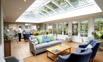 a spacious living room with a large skylight , allowing natural light to fill the space at The Barnsdale