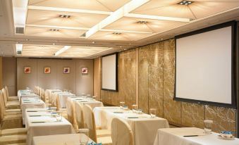 A room in the hotel is set up with tables and chairs for events or functions at The Royal Garden Hotel