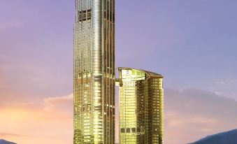 The cityscape features tall buildings with an office tower in the center, as observed from a distance at Nina Hotel Tsuen Wan West