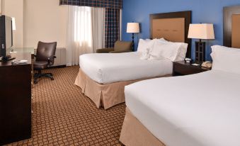 a hotel room with two beds , one on the left and one on the right side of the room at Ramada Plaza by Wyndham Sheridan Hotel & Convention Center