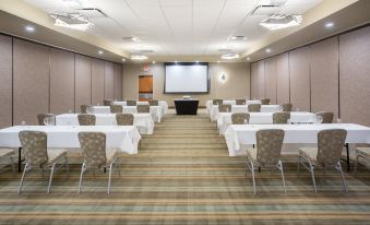 a conference room set up for a meeting , with tables and chairs arranged in rows at Holiday Inn Riverton-Convention Center