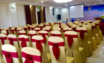 a large conference room with rows of chairs arranged in a semicircle , ready for an event at Amanda Hotel