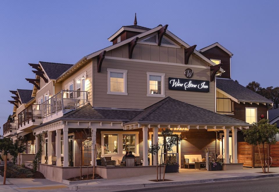 "a restaurant called "" willow grove inn "" with a large sign above the entrance , located on a street with other buildings in the background" at Wine Stone Inn