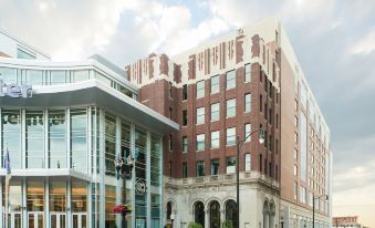 a large brick building with a modern design and a smaller version of the same building in the background at Renaissance Allentown Hotel