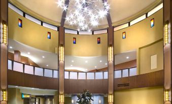 a large , open room with a circular table in the center and several chairs surrounding it at Desert Diamond Casino