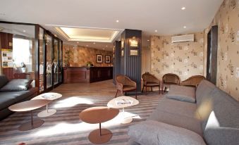 a modern hotel lobby with various seating options , including couches , chairs , and tables , as well as a reception desk at Red Fox