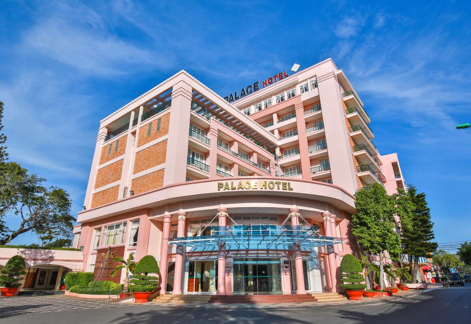 "a pink hotel building with a sign that reads "" palace hotel "" prominently displayed on the front" at Palace Hotel