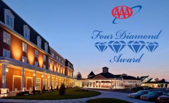 a large hotel with multiple buildings , including a three - story building and a small hotel , under a clear blue sky at Saratoga Casino Hotel