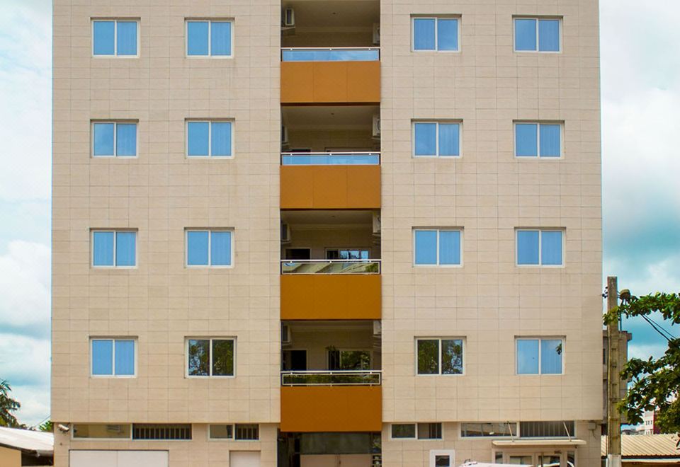 a modern apartment building with multiple windows and a car parked in front of it at Residence Maryka II