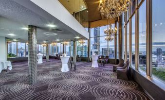 a large , modern room with purple and gray carpeting and a chandelier hanging from the ceiling at Mercure Brisbane Spring Hill