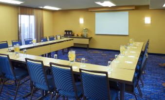 a conference room set up for a meeting , with chairs arranged in a semicircle around a long table at Courtyard Chicago Deerfield