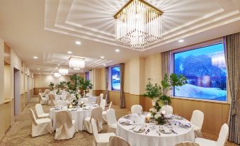 a large dining room with tables and chairs set up for a formal event , possibly a wedding reception at The Westin Rusutsu Resort