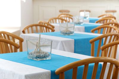 a dining room with several tables and chairs arranged for a group of people to enjoy a meal together at Hotel Summery