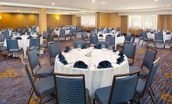 a large dining room with round tables and chairs set up for a formal event at Courtyard Montvale
