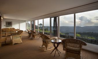 a modern , minimalist living room with large windows offering a view of the surrounding landscape at Volcano House