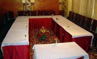 a large dining room with multiple tables set up for a formal event , possibly a wedding reception at Indiana Hotel