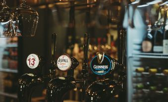 a row of beer taps with various beer labels are lined up in a bar at Hare and Hounds