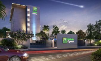 "a hotel with a car parked in front of it and a sign that reads "" holiday inn express ""." at Holiday Inn Express Kolkata Airport