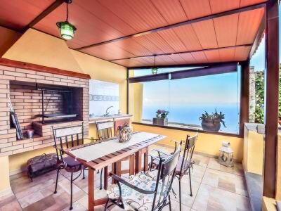 a dining room with a wooden table and chairs , surrounded by a kitchen area with a fireplace at Titi Titi Photo