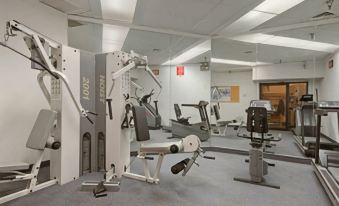 a well - equipped gym with various exercise equipment , including treadmills and weight machines , on the first floor at Days Inn by Wyndham Lanham Washington DC