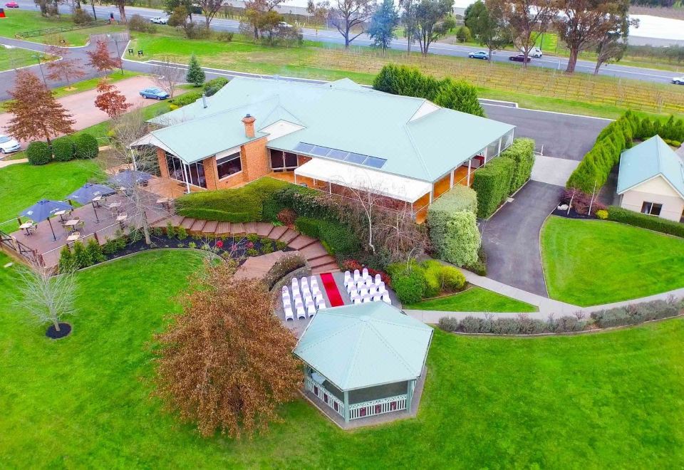 aerial view of a large house surrounded by green grass and trees , with a gazebo in the yard at Wild Cattle Creek Estate