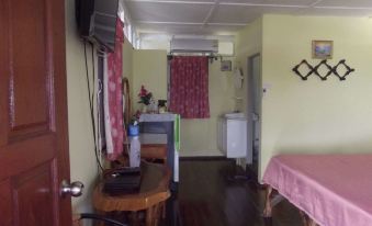 a small room with a bed , a desk , and a television mounted on the wall at Holiday Resort