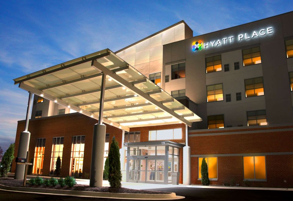 "a large hotel entrance with a sign that reads "" hyatt place "" prominently displayed on the building" at Hyatt Place Augusta