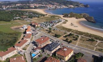 aerial view of a beach town with multiple buildings and a large body of water at Hotel Gala