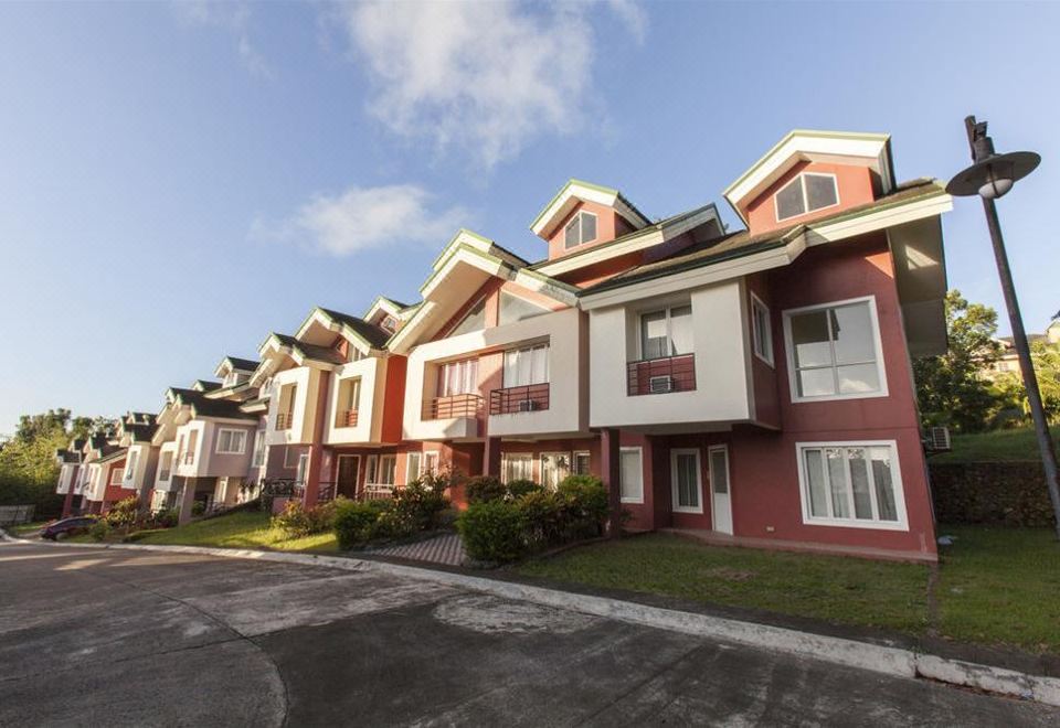 a row of red and white houses with a clear blue sky in the background at Canyon Woods Resort Club